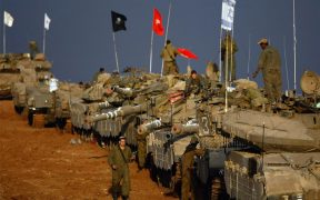Scores of Israeli army tanks and armored personnel carriers are massed on December 29, 2008 near Israel's border with the Gaza Strip.