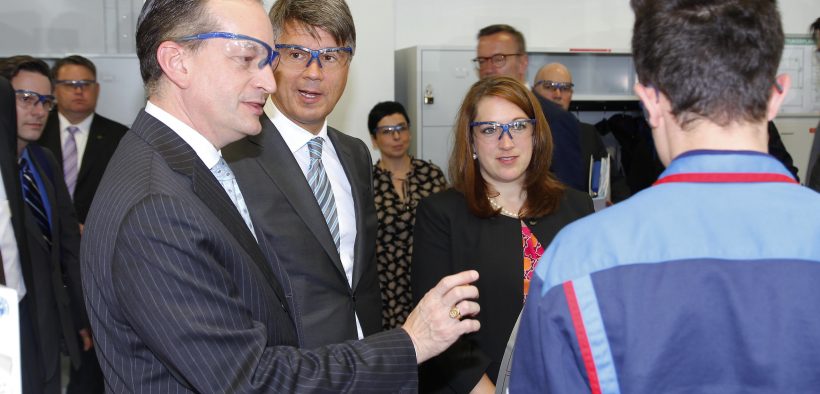Secretary of Labor Alexander Acosta and BMW CEO Harald Krueger meet BMW apprentice at a technical apprentice training workshop