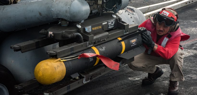 Sailor inspects the mounting of a Hellfire missile on an MH-60R Sea Hawk helicopter.