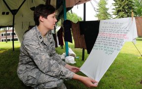 U.S. Air Force Capt. Penny Ripperger, the sexual assault response coordinator with the 119th Wing, North Dakota Air National Guard, reads a poem written on a T-shirt at a Clothesline Project visual display on the Veteran's Administration Hospital grounds in Fargo, N.D., July 29, 2010. The Clothesline Project display uses T-shirts created by victims of military sexual trauma to raise awareness and as part of the healing process.