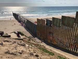 The U.S.-Mexico border wall extends into the Pacific Ocean with Playa Tijuana, Mexico to the south and San Ysidro, California to the north. The existing wall was built during the Clinton Administration. (Photo: Lauren von Bernuth)