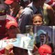 Supporters of Maduro hold up poster showing their support for Venezuelan President Nicolas Maduro at a rally for Maduro.