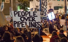 Protesters against the Dakota Access Pipeline and Keystone XL Pipeline hold a sit-in in the street next to the San Francisco Federal Building.