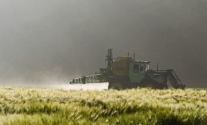 farmer spraying pesticides