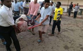 Protestors carrying an injured woman during Khartoum massacre.
