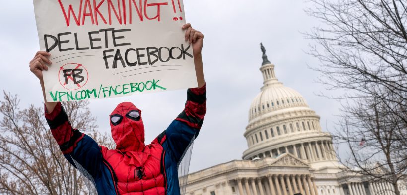 Facebook protester with Warning Delete Facebook sign, Washington DC