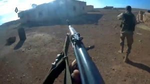 Militants of Hayat Tahrir al-Sham (HTS) fighters storm the village of Mushairfa, northeast of Hama, during the Northeastern Hama offensive (2017). The Image is part of a video taken by a helmet camera.