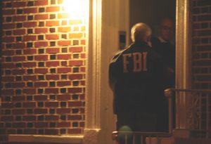 An FBI agent knocks on a door in Brooklyn in 2011 as part of a raid on N.Y. mafia. (Photo: FBI)