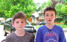 Ben and Carter Wilson, ages 10 and 8, set up a lemonade stand in front of their Overland Park, Kansas, home