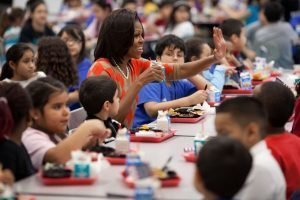 First Lady Michelle Obama and Agriculture Secretary Tom Vilsack visit Parklawn Elementary School in Alexandria, Virginia, Jan. 25, 2012. They join children for lunch in the cafeteria where the school's food service employees and celebrity cook Rachael Ray serve a healthy meal that meets the United States Department of AgricultureÕs (USDA) new and improved nutrition standards for school lunches. (Photo: Official White House Photo by Chuck Kennedy)