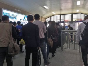 Uighurs wait in line at a face scan checkpoint in Turpan, Xinjiang in northwest China on April 11, 2018. Darren Byler, CC BY