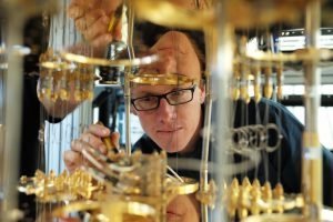 In this photo, IBM scientist Stefan Filipp, takes a closer look at the cryogenic refrigerator which will keep qubits are temperatures colder than the deepest parts of outer space.