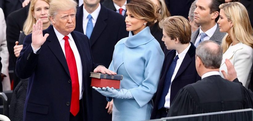 President Donald Trump being sworn in on January 20, 2017 at the U.S. Capitol building in Washington, D.C. Melania Trump wears a sky-blue cashmere Ralph Lauren ensemble. He holds his left hand on two versions of the Bible, one childhood Bible given to him by his mother, along with Abraham Lincoln’s Bible.