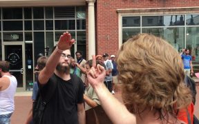 A counter-protester gives a white supremacist the middle finger. The white supremacists responds with a Nazi salute. Charlottesville August 12, 2017.