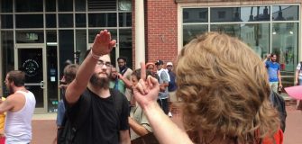 A counter-protester gives a white supremacist the middle finger. The white supremacists responds with a Nazi salute. Charlottesville August 12, 2017.