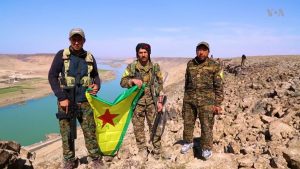 Fighters of the People's Protection Units of the Syrian Democratic Forces on the bank of the Euphrates east of the city of Raqqa in northern Syria.