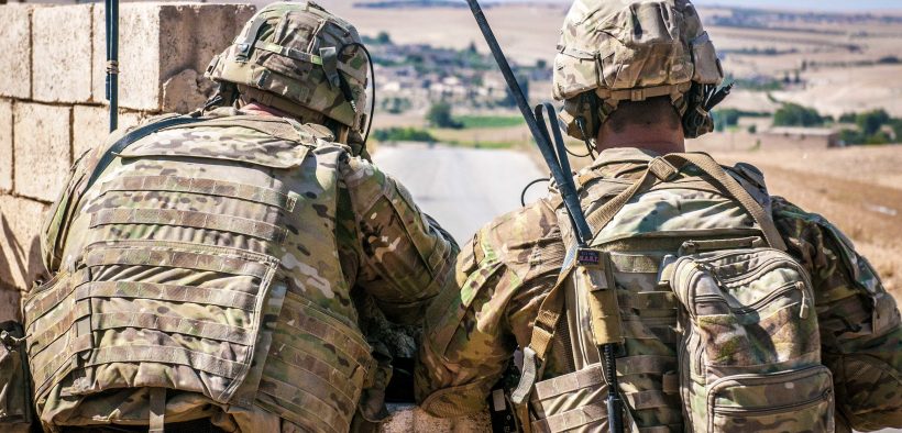 Two U.S. Soldiers keep an eye on the demarcation line during a security patrol outside Manbij, Syria, June 26, 2018.