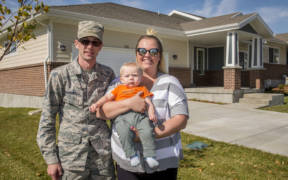 Staff Sgt. Austin Marshall, 84th Radar Evaluation Squadron, his spouse Heather, and 8-month-old son Law pose for a photo in front of their new base housing unit at Hill Air Force Base, Utah, Oct. 11, 2017.