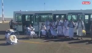 Saudi-held Houthi prisoners of war disembark at Sanaa International Airport in Yemen.