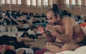 Bikram Choudhury teaching a group yoga class in Bikram: Yogi, Guru, Predator.