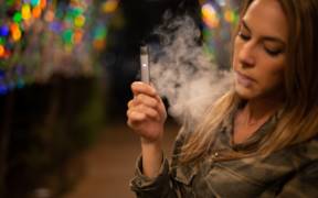 teen using a vaporizer or e-cigarette