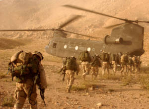 Soldiers quickly march to the ramp of the CH-47 Chinook helicopter that will return them to Kandahar Army Air Field on Sept. 4, 2003. The Soldiers were searching in Daychopan district, Afghanistan, for Taliban fighters and illegal weapons caches. The Soldiers are assigned to Company A, 2nd Battalion, 22nd Infantry Regiment, 10th Mountain Division. (Photo: U.S. Army, Staff Sgt. Kyle Davis)