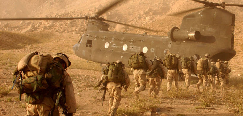 Soldiers quickly march to the ramp of the CH-47 Chinook helicopter that will return them to Kandahar Army Air Field on Sept. 4, 2003. The Soldiers were searching in Daychopan district, Afghanistan, for Taliban fighters and illegal weapons caches. The Soldiers are assigned to Company A, 2nd Battalion, 22nd Infantry Regiment, 10th Mountain Division. (Photo: U.S. Army, Staff Sgt. Kyle Davis)