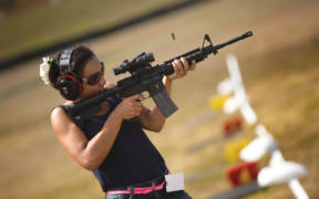 Sarah Richardson, a friend of a Department of Defense employee who works on Marine Corps Base Hawaii, Fires an M4A1 service rifle during the recreational shoot hosted by the Kaneohe Bay Range Training Facility aboard the base. (U.S. Marine Corps Photo By Cpl. Matthew Callahan)