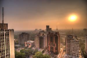 Sun setting at Connaught Place in Delhi. The air was so full of smog particles that the sun often disappeared completely into the fog. View from the revolving Parikrama rooftop restaurant. November 2006.