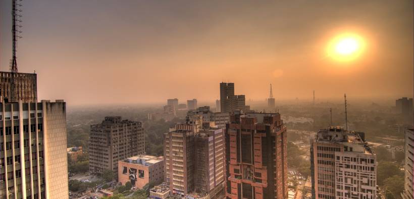Sun setting at Connaught Place in Delhi. The air was so full of smog particles that the sun often disappeared completely into the fog. View from the revolving Parikrama rooftop restaurant. November 2006.