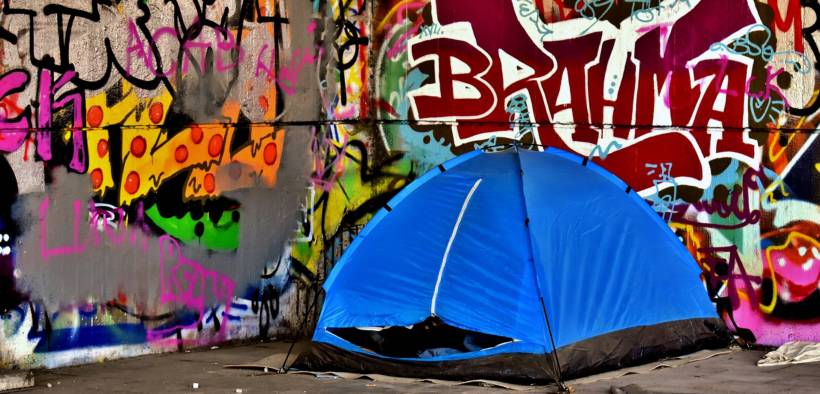 homeless person in tent. Homeless bans now in some states are banning sleeping in public tents.