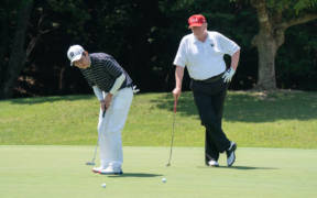 President Donald J. Trump watches as Japan Prime Minister Shinzo Abe makes a putt during their golf game Sunday, May 26, 2019, at the Mobara Country Club in Chiba, Japan. (Official White House Photo by Shealah Craighead)