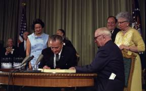1280px Lyndon Johnson signing Medicare bill with Harry Truman July 30 1965