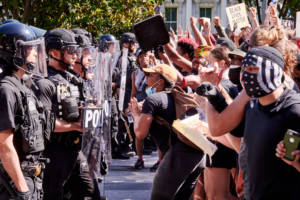 Protestors confront the Secret Service in front of the Old Executive Office Building on Pennsylvania Avenue. Lafayette Park and access to the White House had been barricaded. Protestors were there in a second day of DC protests against the police brutality in the death of George Floyd. However, after days of taunts from the President, the protest had featured strong anti-Trump chants.